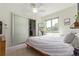 This bright bedroom includes a ceiling fan and a closet with frosted glass sliding doors at 3325 Irving St, Denver, CO 80211