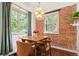 Charming dining area with exposed brick and a modern light fixture at 3325 Irving St, Denver, CO 80211