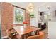 Charming dining area featuring exposed brick and a view into kitchen area at 3325 Irving St, Denver, CO 80211