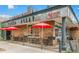 Classic Pizza Alley exterior established since 1976, featuring outdoor seating under bright red umbrellas at 3325 Irving St, Denver, CO 80211