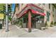 Corner view of Mondo Vino with a red awning, greenery, and open storefront on a sunny day at 3325 Irving St, Denver, CO 80211