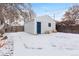 Backyard with detached garage in winter, offering ample space and a functional outdoor structure at 3438 N York St, Denver, CO 80205