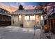 Backyard with snow, featuring a quaint home with string lights at dusk, creating a cozy ambiance at 3438 N York St, Denver, CO 80205