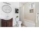 A bright bathroom features a shower over tub and a modern sink at 3438 N York St, Denver, CO 80205