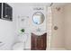 A bright bathroom features a shower over tub and a modern sink at 3438 N York St, Denver, CO 80205