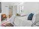 Bright bedroom offers a calming retreat with a bed, a chair, and a plant near a window at 3438 N York St, Denver, CO 80205