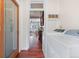 A laundry room features a washer, dryer and view into the main living space and pantry at 3438 N York St, Denver, CO 80205