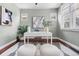 Bright office with hardwood floors, a white desk, modern art and a black and white striped rug at 3438 N York St, Denver, CO 80205