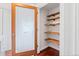 A pantry with an decorative glass door has wood shelves and hardwood flooring at 3438 N York St, Denver, CO 80205