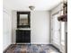 Welcoming entryway featuring slate tile floors, a decorative mirror, and storage cabinet at 377 Pearl St # 5, Boulder, CO 80302