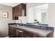 Close-up of the sink area of the modern kitchen, featuring dark wood cabinets at 377 Pearl St # 5, Boulder, CO 80302