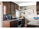 Kitchen features dark wood cabinets, granite countertops, stainless steel appliances, and blue tile at 377 Pearl St # 5, Boulder, CO 80302
