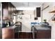 Galley kitchen features modern cabinets, tile backsplash, and stainless steel appliances at 377 Pearl St # 5, Boulder, CO 80302