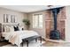 Cozy bedroom features a brick fireplace and a black metal bed frame at 377 Pearl St # 5, Boulder, CO 80302