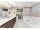 Luxurious bathroom featuring a soaking tub, marble countertops, and elegant fixtures at 2001 Lincoln St # 2524, Denver, CO 80202