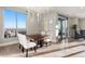 Bright dining room with chandelier, wood floors, and city views from the large windows, great for entertaining guests at 2001 Lincoln St # 2524, Denver, CO 80202