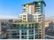 Stunning high-rise condo building featuring modern architecture, curved glass, and multiple balconies against a clear blue sky at 2001 Lincoln St # 2524, Denver, CO 80202