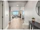 Inviting hallway leads to an open-concept living area with stunning city views and hardwood floors at 2001 Lincoln St # 2524, Denver, CO 80202