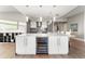 Contemporary kitchen with a large island, built-in wine fridge, and modern appliances at 2001 Lincoln St # 2524, Denver, CO 80202