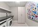 Bright laundry room with modern front loading washer/dryer, ample storage, and stylish countertops at 2001 Lincoln St # 2524, Denver, CO 80202