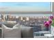 Serene city view from the living room window with plush seating and natural light at 2001 Lincoln St # 2524, Denver, CO 80202
