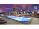 Rooftop pool with city skyline views, lounge chairs, and ambient lighting at dusk at 2001 Lincoln St # 2524, Denver, CO 80202