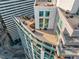Aerial view of a rooftop terrace featuring lounge seating, a grill, and city views at 2001 Lincoln St # 2524, Denver, CO 80202