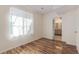 Bright bedroom with modern flooring and a window providing natural light and a glimpse into the connected bathroom at 1226 S Fulton St, Aurora, CO 80247