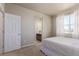 Carpeted bedroom with white walls and ensuite bathroom at 1226 S Fulton St, Aurora, CO 80247