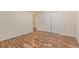 Bedroom with wood-look floors, a neutral wall, and doorways and closet space for ample storage at 1226 S Fulton St, Aurora, CO 80247