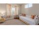 Bright bedroom featuring neutral tones, carpet, and decorative furniture with a double window at 1226 S Fulton St, Aurora, CO 80247