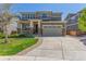 Inviting two-story home featuring a spacious driveway and well-maintained landscaping at 1226 S Fulton St, Aurora, CO 80247