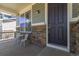 Cozy front porch with stone accents and seating, perfect for relaxing outdoors at 1226 S Fulton St, Aurora, CO 80247
