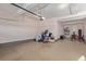 Spacious garage with exposed ceiling beams, ample storage, and a doorway leading to the interior of the house at 1226 S Fulton St, Aurora, CO 80247