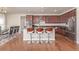 Modern kitchen featuring an island with seating, stainless steel appliances, and hardwood floors at 1226 S Fulton St, Aurora, CO 80247