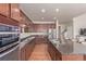 Well-appointed kitchen with stainless steel appliances, granite countertops, and ample cabinet space at 1226 S Fulton St, Aurora, CO 80247