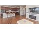 Open-concept living area with a kitchen island, hardwood floors, and cozy fireplace at 1226 S Fulton St, Aurora, CO 80247