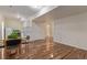 Open-concept living space featuring laminated floors and small kitchen at 1226 S Fulton St, Aurora, CO 80247