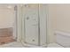 Corner shower with sliding glass door, shelving, and sleek fixtures, connected to a bedroom space in the background at 1226 S Fulton St, Aurora, CO 80247
