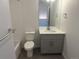 Bathroom with white subway tile, toilet, tub, and a vanity with gray cabinet at 1315 N Alton St, Aurora, CO 80010