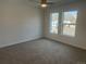 Bedroom featuring two windows, a modern ceiling fan, and neutral carpeting at 1315 N Alton St, Aurora, CO 80010