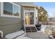 Back patio with access from sliding glass doors, small steps, and partial snow cover at 16935 Buffalo Valley Path, Monument, CO 80132