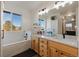 Main bathroom with double vanity, soaking tub, and window views at 16935 Buffalo Valley Path, Monument, CO 80132