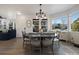 Bright dining area with a large round table and chairs, hardwood floors, and views to backyard at 16935 Buffalo Valley Path, Monument, CO 80132