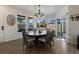 Bright dining area with a large round table and chairs, hardwood floors, and views to backyard at 16935 Buffalo Valley Path, Monument, CO 80132