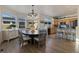 Bright dining area with a large round table and chairs, hardwood floors, and access to the kitchen at 16935 Buffalo Valley Path, Monument, CO 80132