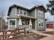 Inviting two-story home with a cozy porch, wooden fence, and professional landscaping at 16935 Buffalo Valley Path, Monument, CO 80132