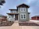 Charming two-story home features a covered porch with stone accents and a well-maintained front yard at 16935 Buffalo Valley Path, Monument, CO 80132