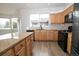 Modern kitchen boasting granite countertops, wood cabinets, stainless steel appliances, and a large island at 16935 Buffalo Valley Path, Monument, CO 80132