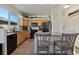 Modern kitchen with light wood cabinets, granite countertops, and stainless steel appliances at 16935 Buffalo Valley Path, Monument, CO 80132